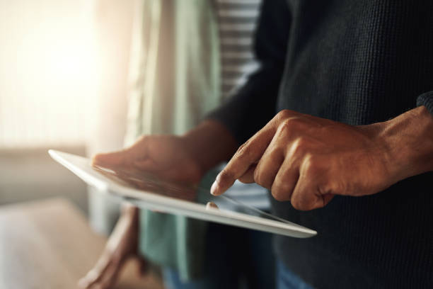 istock Close-up of a man touching on digital tablet 1152853065