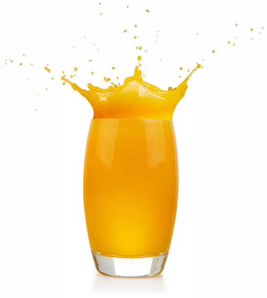 istock orange juice splashing glass isolated 1152854444
