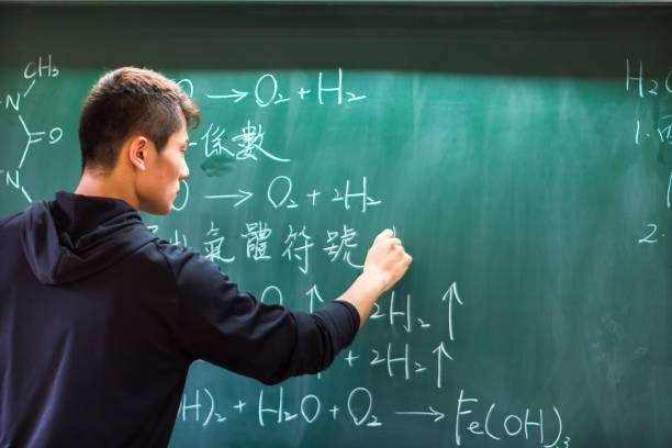 istock Asian university student solving chemistry formula on the black board 1152854849