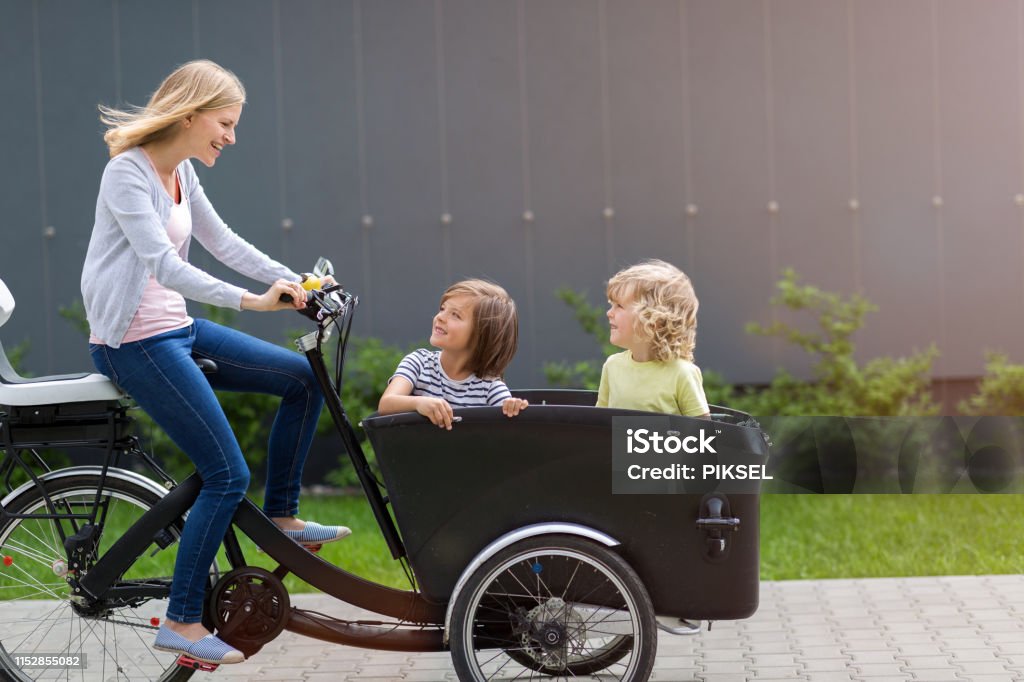 Mother and children having a ride with cargo bike Cargo Bike Stock Photo