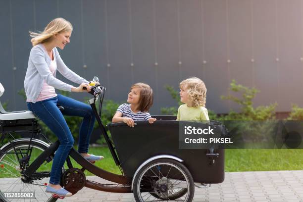 Mother And Children Having A Ride With Cargo Bike Stock Photo - Download Image Now - Cargo Bike, Electric Bicycle, Bicycle