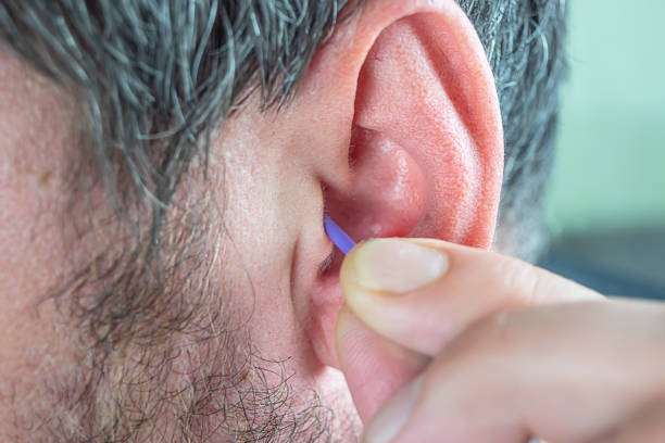 istock a man cleans his ears with a cotton swab 1152856939