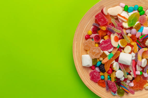 istock Colorful candies on green background 1152856985