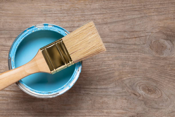 istock Paint brush and can on wooden table 1152859226
