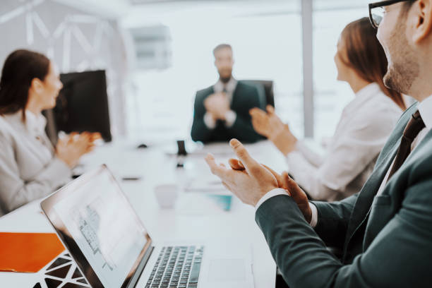 istock Positive dedicated business people dressed in suits clapping for successfully done job. 1152860096