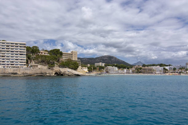 Sailboat moored in Cala Fornells turquoise water SANTA PONSA, MALLORCA, SPAIN - MAY 29, 2019: Hotel in Paguera from sea turquoise water on May 29, 2019 in Santa Ponsa, Mallorca, Spain. seaside views of cala fornells mallorca stock pictures, royalty-free photos & images