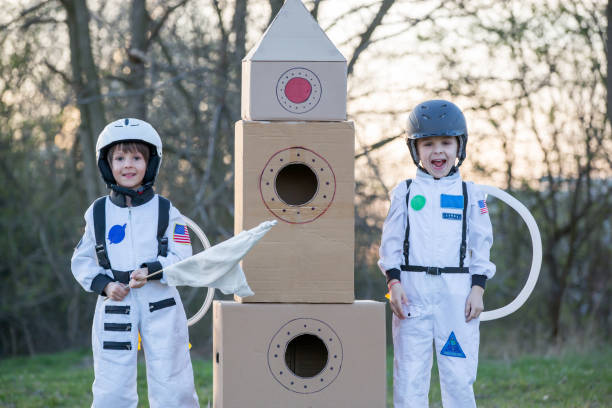istock Two adorable children, playing in park on sunset, dressed like astronauts 1152860314