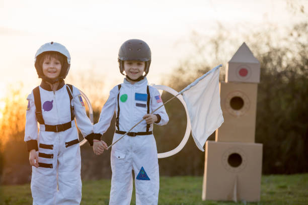istock Two adorable children, playing in park on sunset, dressed like astronauts 1152860888