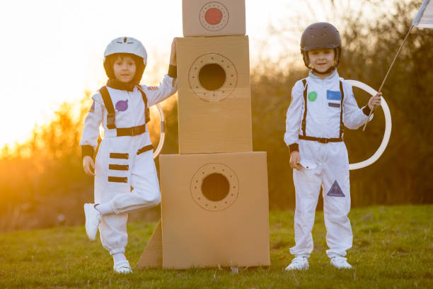 istock Two adorable children, playing in park on sunset, dressed like astronauts 1152860917