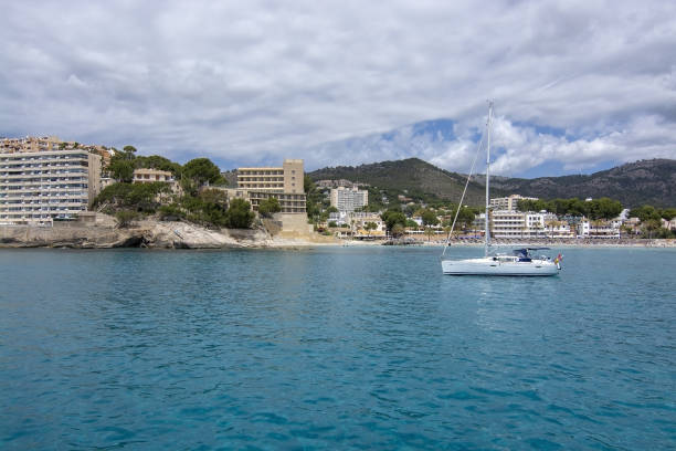 Sailboat moored in Cala Fornells turquoise water SANTA PONSA, MALLORCA, SPAIN - MAY 29, 2019: Sailboat moored in Cala Fornells turquoise water on May 29, 2019 in Santa Ponsa, Mallorca, Spain. seaside views of cala fornells mallorca stock pictures, royalty-free photos & images