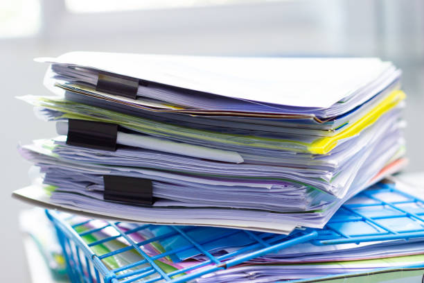 istock file folder and Stack of business report paper file on the table in a work office 1152861764