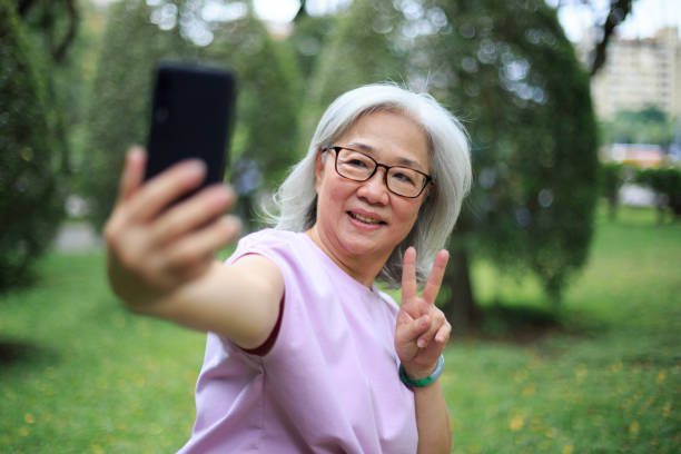 istock Senior lady taking selfie in the park 1152864017