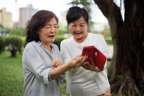 istock Senior ladies laughing looking at smart phone 1152864035