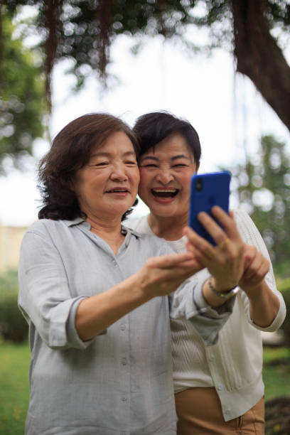 istock Two senior ladies laughing looking at smart phone 1152864049