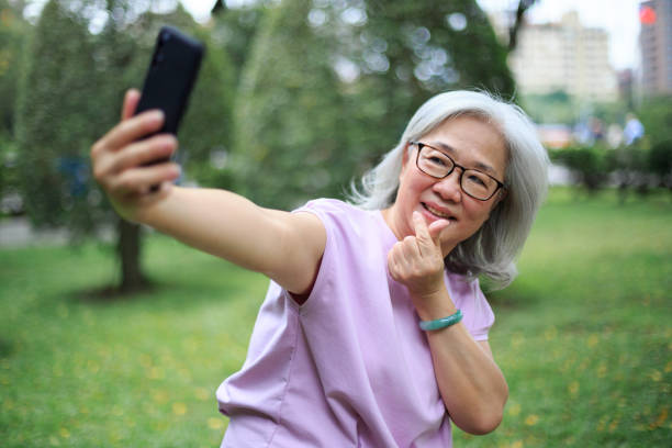 istock Senior lady taking selfie in the park 1152864051
