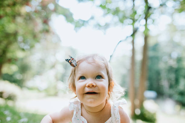 A beautiful little baby girl looking into the camera speaks and congratulates mother on the day of mother and father's day father. flat lay. top view.