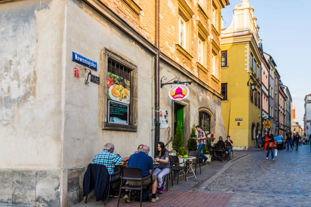 Warsaw Poland. April 2019. A cafe scene in the old town in Warsaw Poland. Warsaw Old Town  is the oldest part of Warsaw, the capital city of Poland. It is bounded by the Vistula Boulevards along with the bank of the Vistula river.