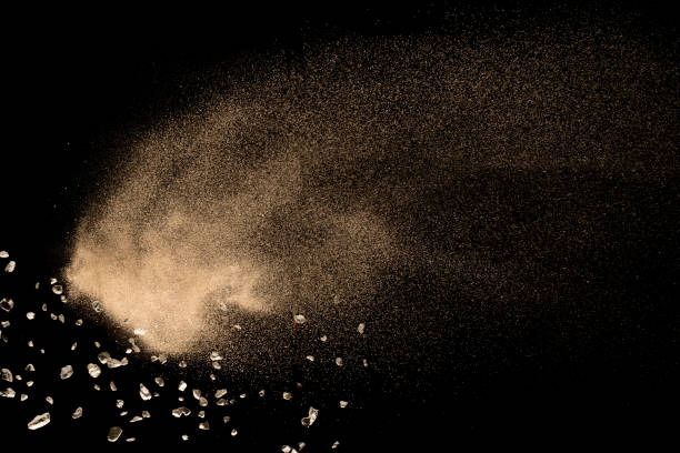 Dry river sand explosion isolated on black background. Abstract sand cloud.Brown colored sand splash against dark background.