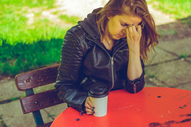istock Tired woman holding her forehead in nature 1152868074