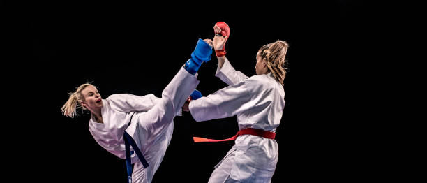istock Female karateka defending from a turning kick 1152868510