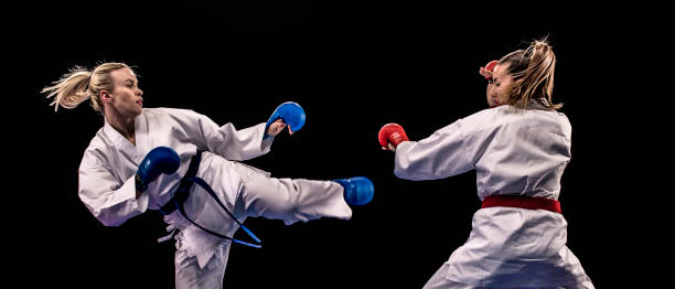 istock Female karateka doing a side kick during a practice match 1152868511