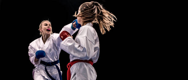 istock Female karateka punching another in the face 1152868517