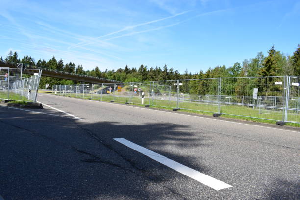 gitter fence around road 2019 Eifel, public road leading to Nürburgring protected by fences to  separate pedestrians and drivers going to an event 2 km away nürburgring stock pictures, royalty-free photos & images