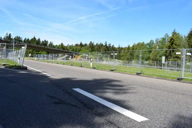 2019 Eifel, public road leading to Nürburgring protected by fences to  separate pedestrians and drivers going to an event 2 km away