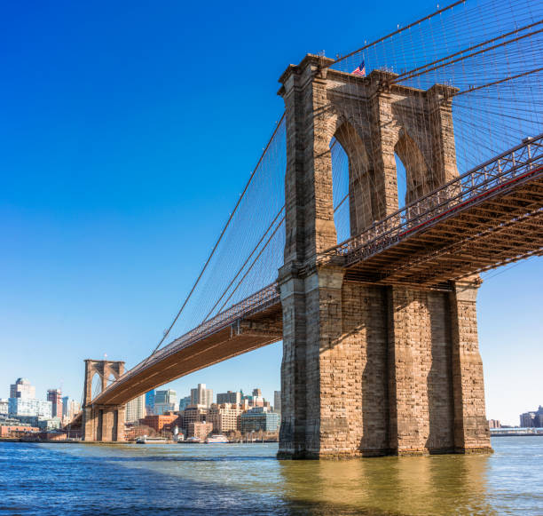 Brooklyn Bridge full span over the East River The iconic Brooklyn Bridge, with the buildings of Brooklyn in the distance. brooklyn bridge new york stock pictures, royalty-free photos & images