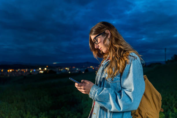 istock Young woman using phone outdoors 1152872268