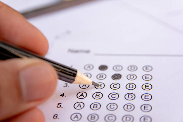 istock Students hand holding pencil writing selected choice on answer sheets and Mathematics question sheets. students testing doing examination. school exam 1152876884