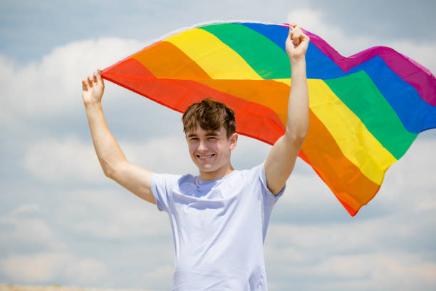istock Caucasian male on a beach holding a Pride flag 1152878575