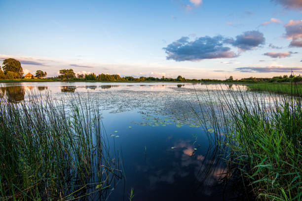 istock clear sky with dramatic clouds over the lake in sunset 1152879983