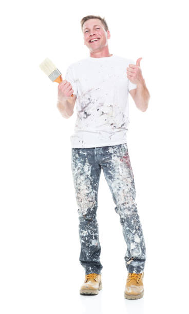 istock Handsome young male painter wearing staned clothes  on white background - thumbs up 1152880937