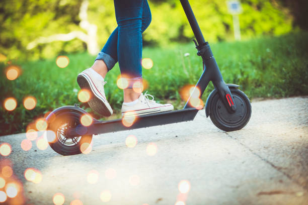 istock Woman riding motor scooter at park 1152881874