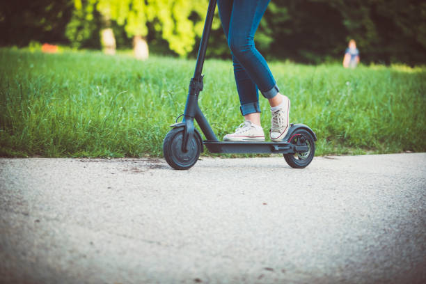 istock Woman riding motor scooter at park 1152882394