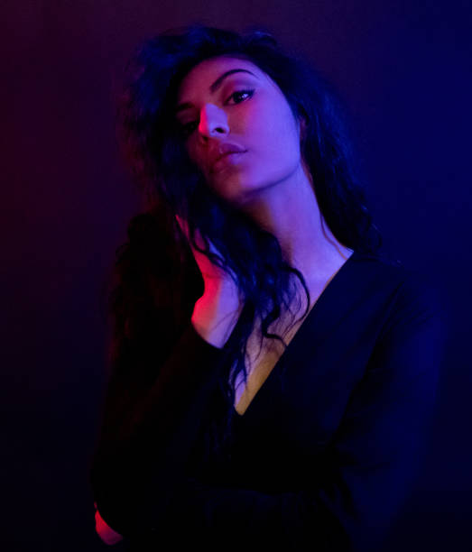 istock Attractive female in blue and red light 1152884278