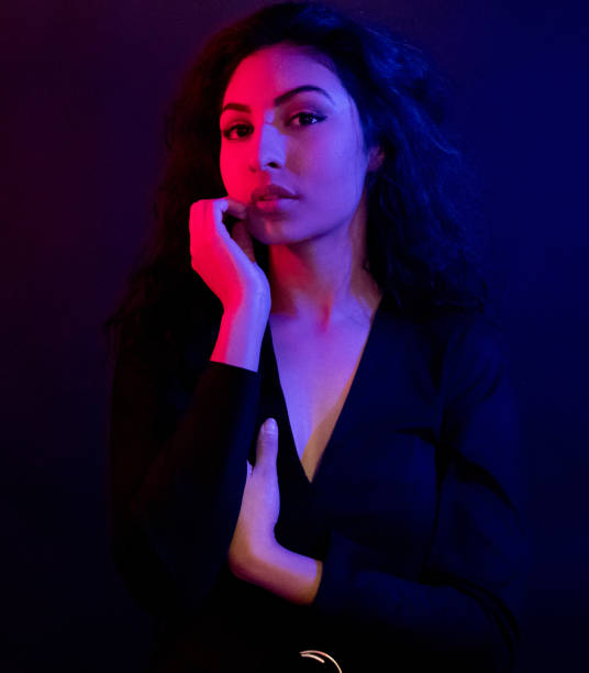 istock Attractive female in blue and red light 1152884567