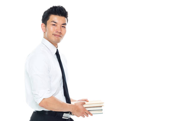 istock Handsome Asian Businessman - is holding books 1152886128