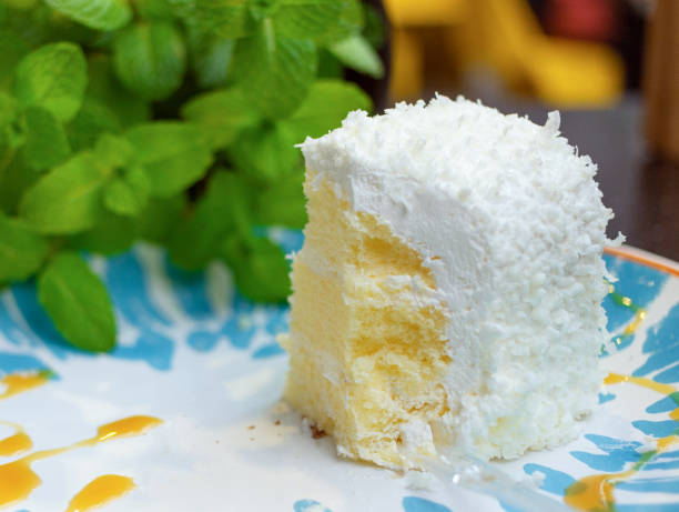 istock Small white mousse cake, blue and white plates and green mint leaves 1152887461