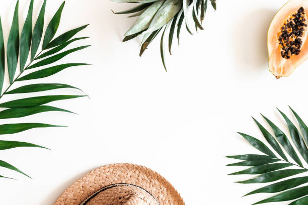 istock Summer composition. Tropical palm leaves, hat, fruits on white background. Summer concept. Flat lay, top view, copy space 1152893336