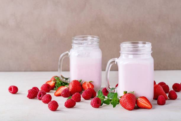 istock Strawberry smoothie in glass jars 1152893704
