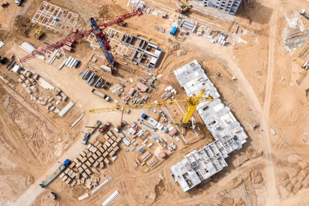 istock industrial machinery working at construction site. drone image. 1152894871