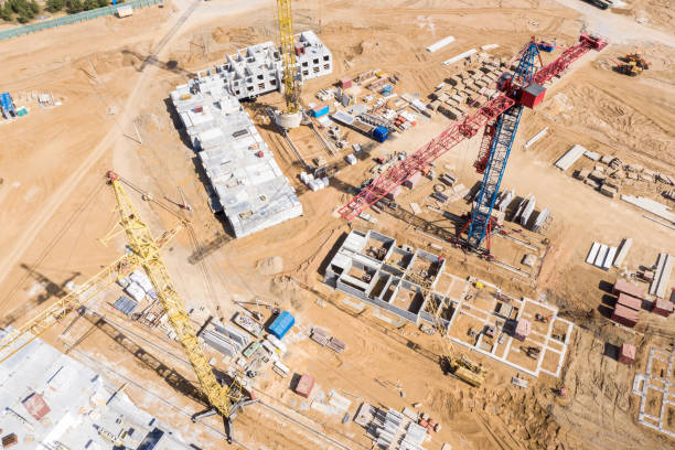 istock drone image of city construction site with tower cranes and building under construction 1152895002