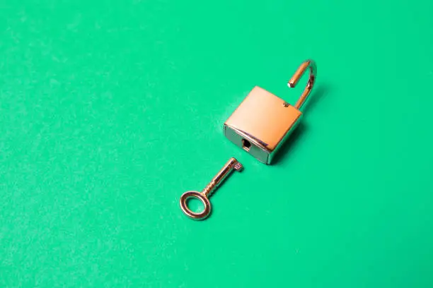 The top view shot of lock and key on a green background