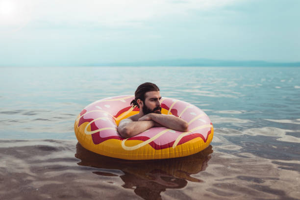 istock Man with an inflatable ring enjoying a day at the seaside 1152895123