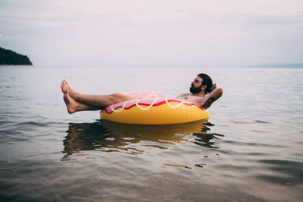 istock Man with an inflatable ring enjoying a day at the seaside 1152895152