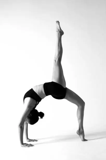 Woman doing yoga exercise, studio shot.