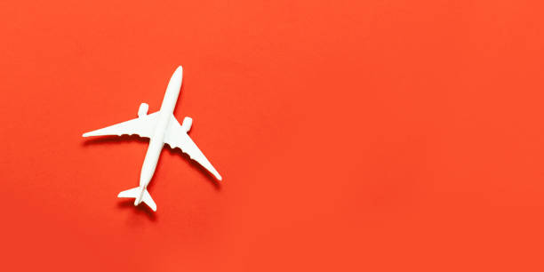 istock Travel concept. Airplane model, airplane on a bright red background. 1152897379