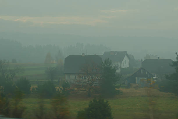 Foggy view of a rural small town and fields.